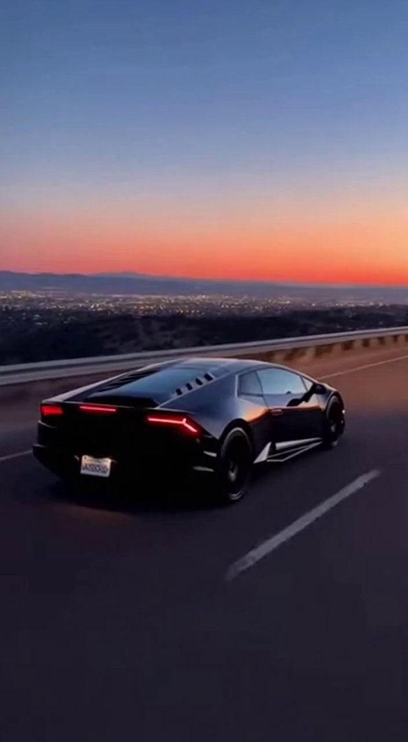 [Sora 2] “Plan ultra-réaliste d’une Lamborghini Huracán noire roulant de nuit sur une route large et dégagée,... - Veo 3 AI video prompt thumbnail