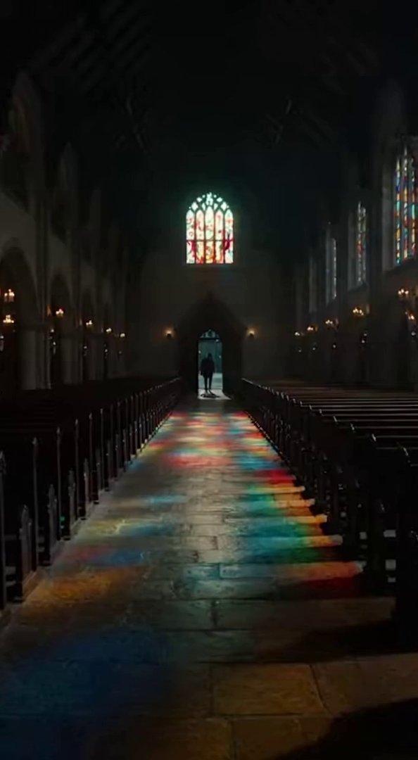 [Sora 2] A dimly lit church interior with wooden beams and stained glass windows casts colorful reflections o... - Veo 3 AI video prompt thumbnail