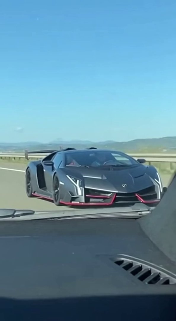 [Sora 2] Ultra-realistic cinematic video, daytime, filmed from inside another car following a Lamborghini Ven...