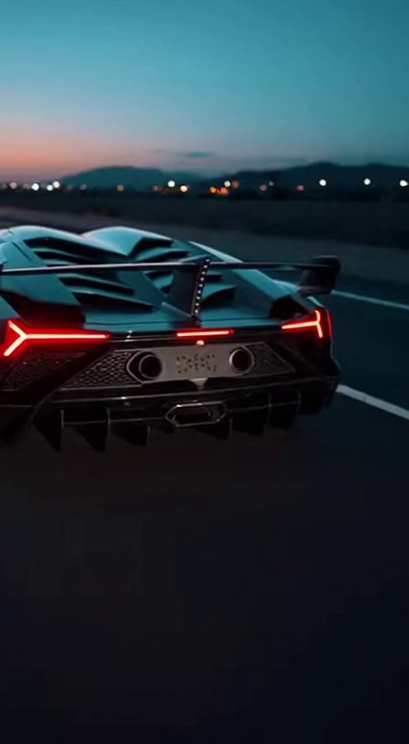 [Sora 2] High-end cinematic sequence of a Lamborghini Veneno Roadster, matte black carbon fiber, racing on an...