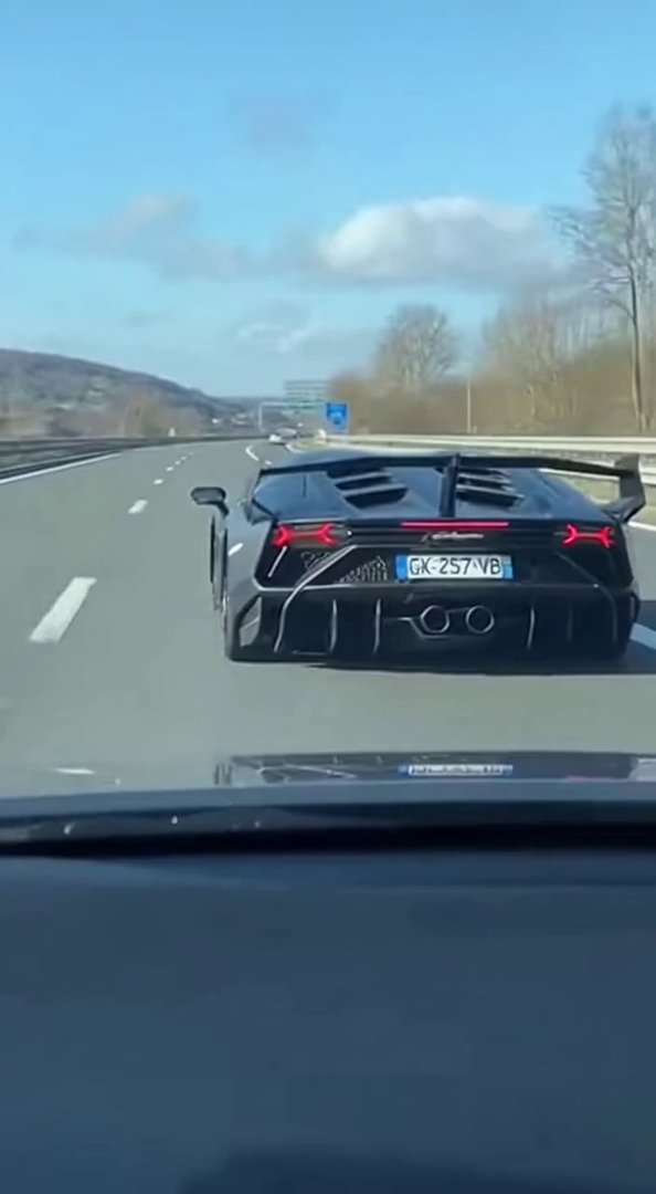 [Sora 2] Ultra-realistic cinematic video, daytime, filmed from inside another car following a Lamborghini Ven...