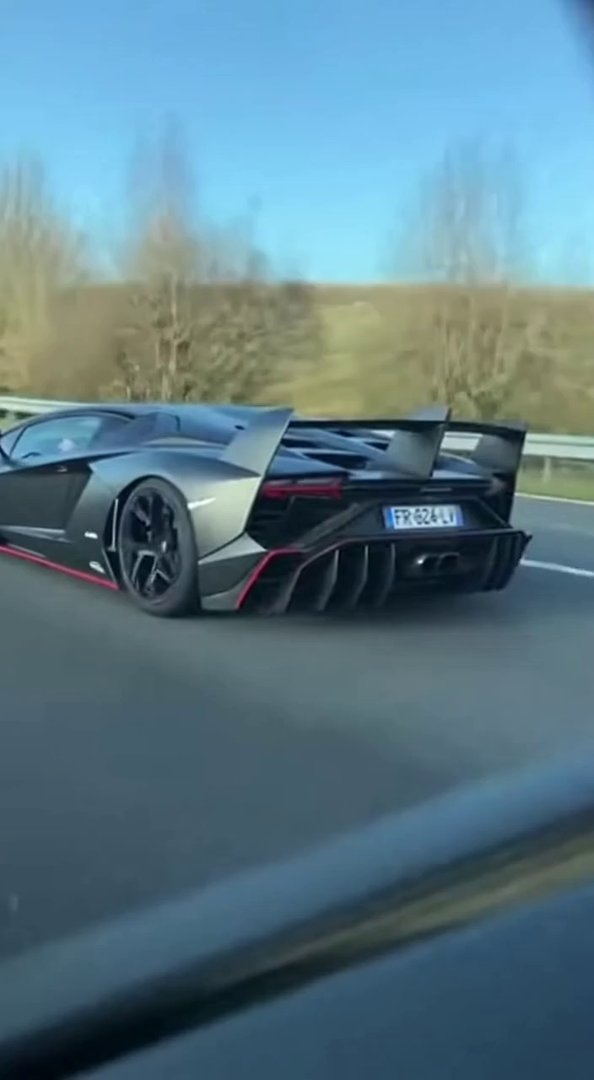[Sora 2] Ultra-realistic cinematic video, daytime, filmed from inside another car following a Lamborghini Ven...